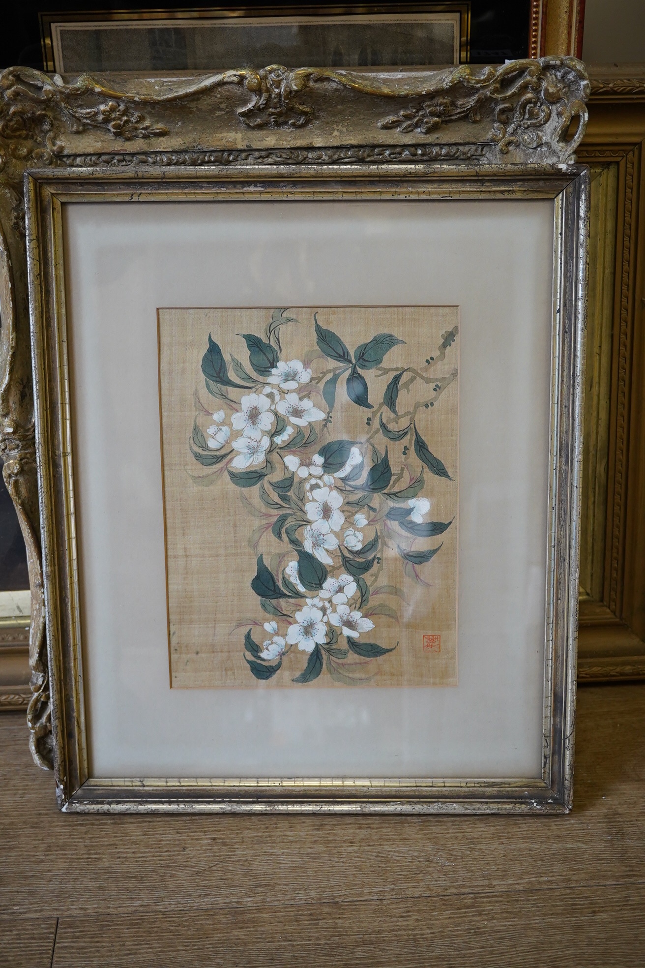 An early 20th century, Chinese School, watercolour on silk, Study of flowers, signed with red seal mark, 26.5 x 19.5cm. Condition - fair, discolouration throughout